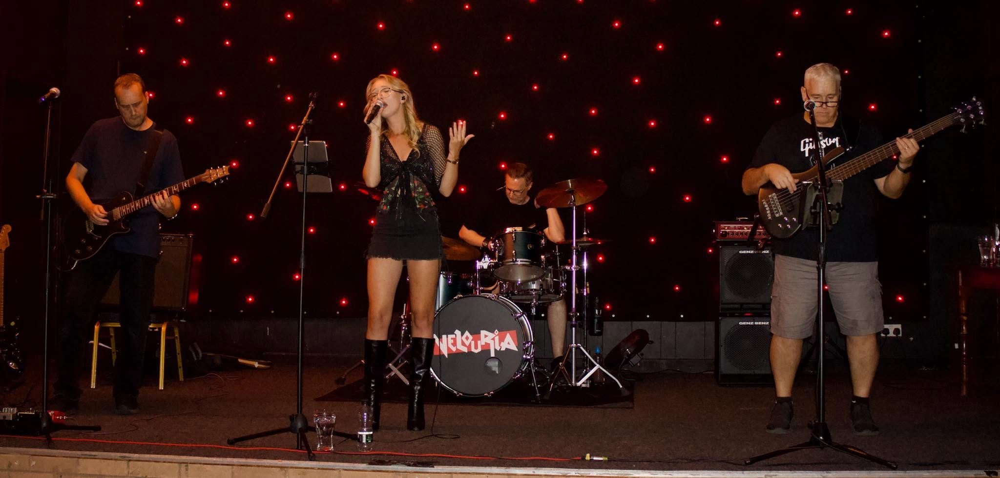 Left to right: Darren Greaves on guitar, Alexis Spillane singing, Martin Catt behind on drums, Rob Mcalindon on bass. Red LED star-cloth behind us.